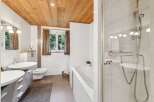 Step into a serene bathroom retreat, featuring a stunning wooden ceiling that adds warmth and character.