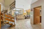 This stunning property features a grand staircase with a unique cowhide carpet, adding a touch of rustic elegance.
