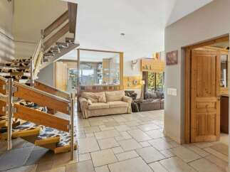 This stunning property features a grand staircase with a unique cowhide carpet, adding a touch of rustic elegance.