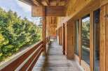 Experience the charm of this stunning wooden property, featuring a spacious balcony perfect for enjoying the serene surroundings.