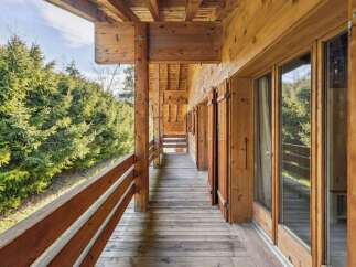 Experience the charm of this stunning wooden property, featuring a spacious balcony perfect for enjoying the serene surroundings.