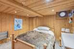 Step into a cozy bedroom retreat featuring rustic wooden accents and a plush, inviting bed.
