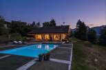 Experience luxury living in this stunning mountain retreat, featuring a pristine swimming pool and a cozy fire pit perfect for evening relaxation.