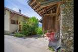 Discover the charm of this unique property, featuring a rustic wooden structure and a cozy outdoor seating area.