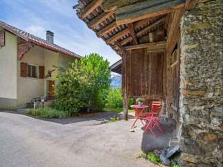 Discover the charm of this unique property, featuring a rustic wooden structure and a cozy outdoor seating area.
