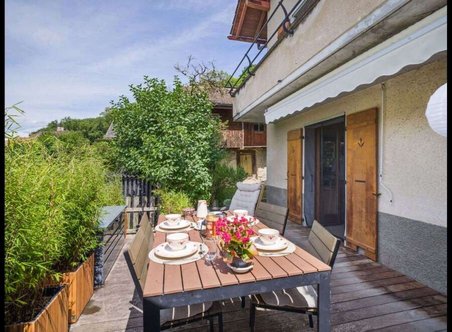 Enjoy outdoor dining in this charming property! This home features a beautiful wooden deck, perfect for entertaining or relaxing.
