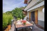 Enjoy outdoor dining in this charming property! This home features a beautiful wooden deck, perfect for entertaining or relaxing.