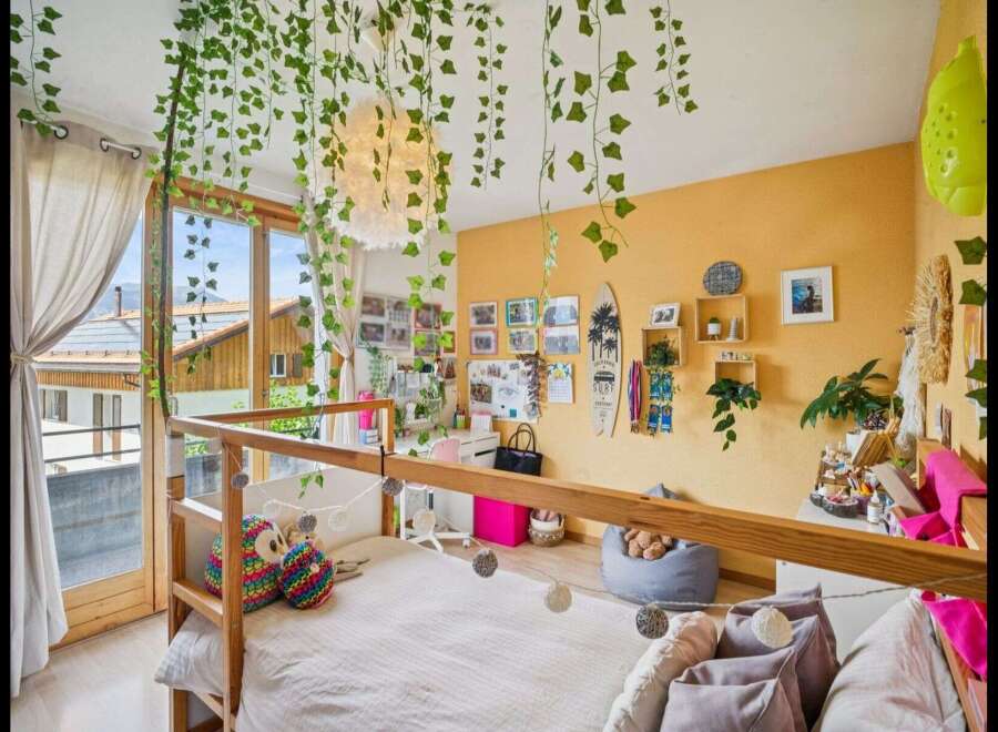 This charming bedroom boasts a unique design with a loft bed and a cozy atmosphere.