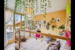 This charming bedroom boasts a unique design with a loft bed and a cozy atmosphere.