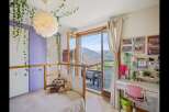This charming bedroom offers a cozy and inviting atmosphere, perfect for relaxation and creativity.