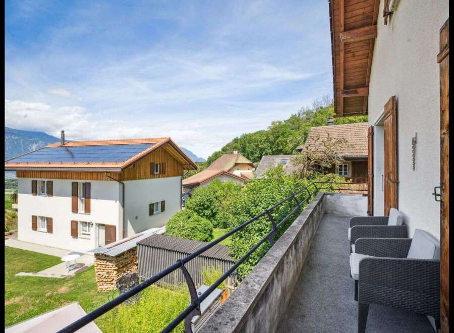 Enjoy stunning views from this charming property! This home features a balcony with comfortable seating, perfect for relaxing and taking in the scenery.
