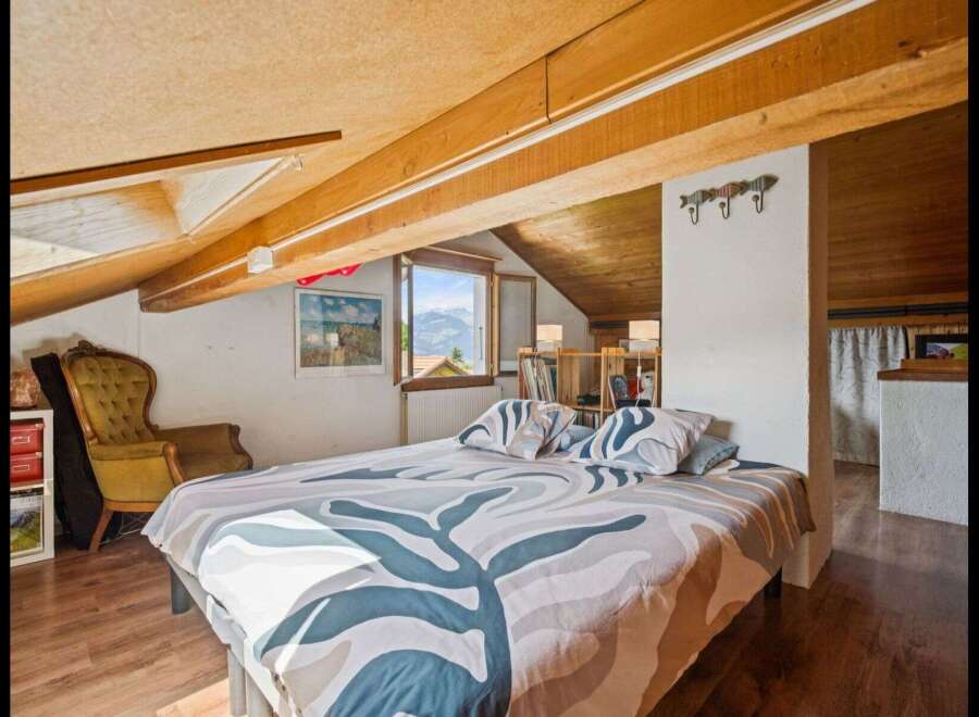 This charming bedroom offers a cozy retreat with its unique architectural details and inviting ambiance.