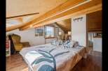 This charming bedroom offers a cozy retreat with its unique architectural details and inviting ambiance.