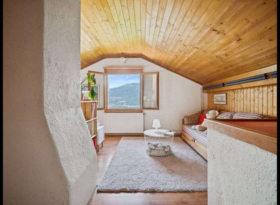 Discover the charm of this cozy attic space, perfect for a guest room or a relaxing retreat.
