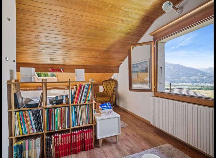 Discover the charm of this cozy attic space, perfect for a home library or reading nook.
