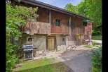 Discover the charm of this unique property featuring a rustic wooden facade and a welcoming outdoor space.