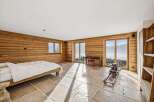 Experience luxury living in this stunning property, featuring a spacious bedroom with breathtaking mountain views.