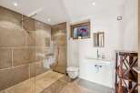 Step into luxury with this stunning bathroom featuring a walk-in shower with a glass enclosure.