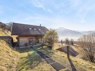 Nestled in a serene mountain landscape, this charming wooden cabin offers a perfect blend of rustic charm and modern comfort.