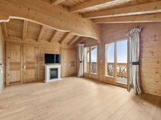 Step into a world of rustic elegance with this stunning property, showcasing exquisite wooden architecture throughout.