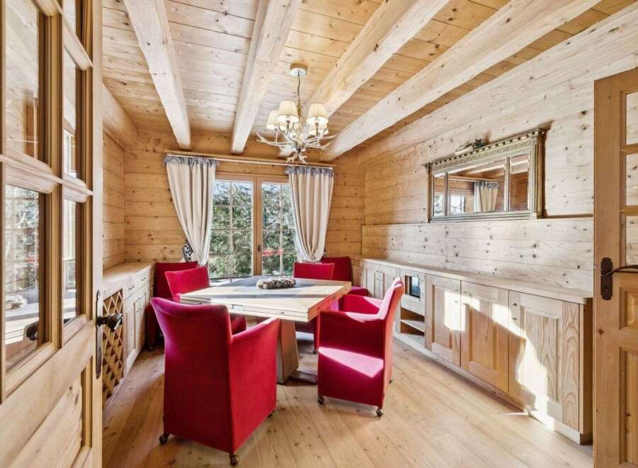 This stunning dining room showcases a warm and inviting atmosphere with its wooden walls and ceiling.