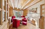 This stunning dining room showcases a warm and inviting atmosphere with its wooden walls and ceiling.