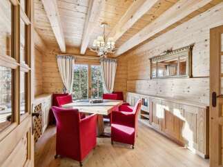 This stunning dining room showcases a warm and inviting atmosphere with its wooden walls and ceiling.