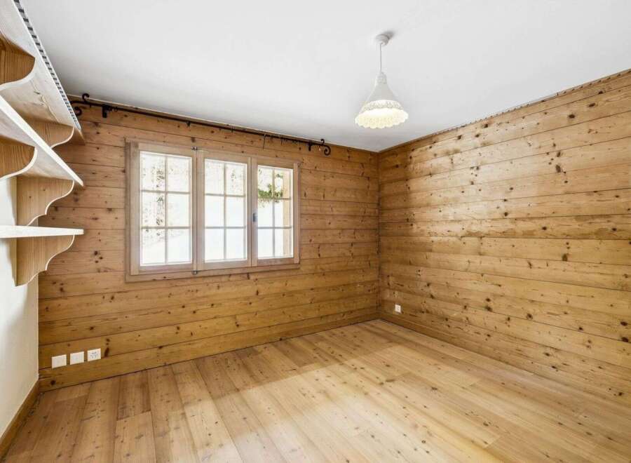 This charming room features beautiful wooden walls and flooring, creating a warm and inviting atmosphere.