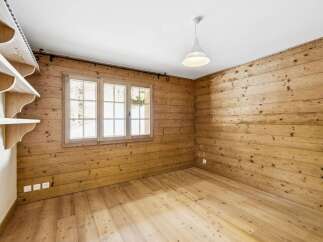 This charming room features beautiful wooden walls and flooring, creating a warm and inviting atmosphere.
