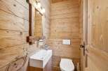 This stunning bathroom showcases a rustic design with wooden paneling, creating a warm and inviting atmosphere.