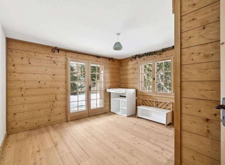 This charming room features beautiful wooden walls and flooring, creating a warm and inviting atmosphere.