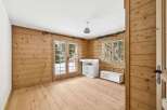 This charming room features beautiful wooden walls and flooring, creating a warm and inviting atmosphere.