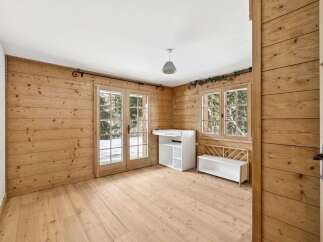 This charming room features beautiful wooden walls and flooring, creating a warm and inviting atmosphere.