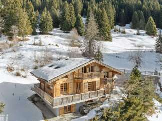 Nestled in a serene winter wonderland, this stunning wooden chalet offers a luxurious escape.