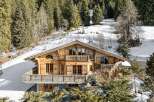 Discover the charm of this stunning wooden chalet nestled in a picturesque mountain setting.