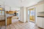 This charming kitchen boasts a warm and inviting atmosphere, perfect for culinary creations and family gatherings.