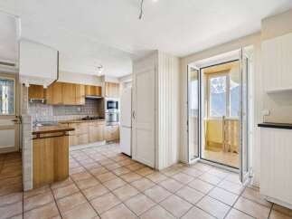 This charming kitchen boasts a warm and inviting atmosphere, perfect for culinary creations and family gatherings.