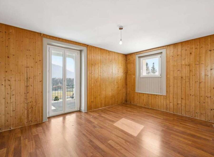 This inviting space features a warm, wooden interior with ample natural light.