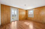 This inviting space features a warm, wooden interior with ample natural light.