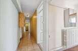Step into this inviting hallway, featuring a warm, tiled floor that leads your eye towards the back.