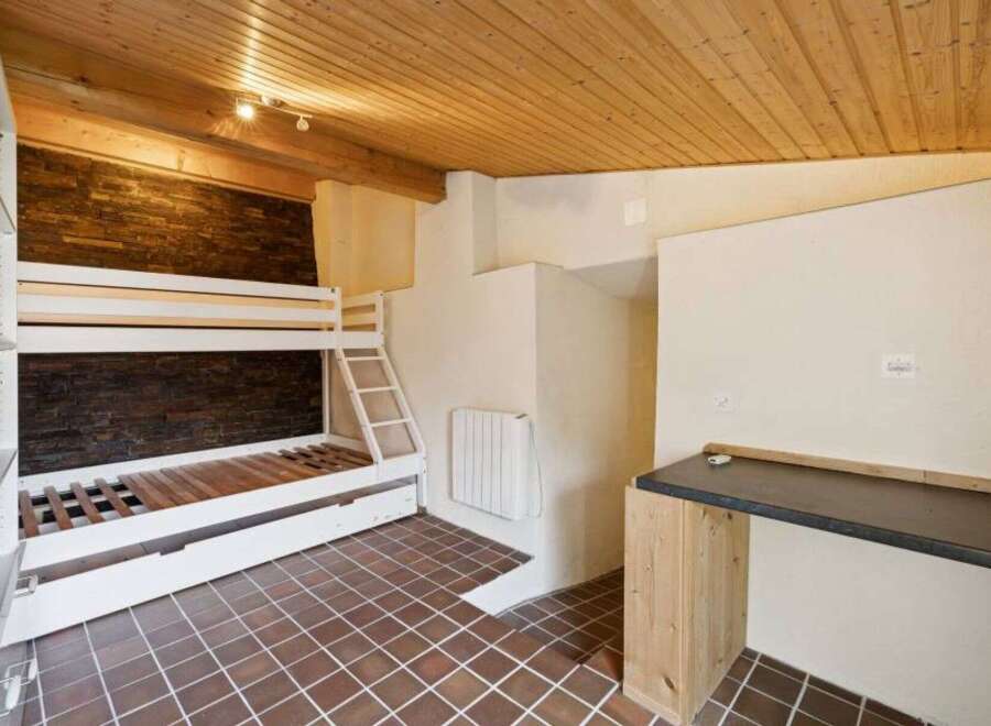 Discover this charming property featuring a cozy bunk bed setup, perfect for maximizing space.