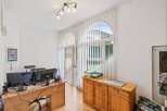 This home office features a spacious wooden desk with dual monitors, perfect for productivity.