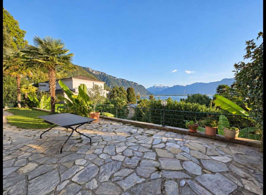 Experience breathtaking lake and mountain views from this stunning property's expansive stone patio.