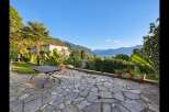 Experience breathtaking lake and mountain views from this stunning property's expansive stone patio.