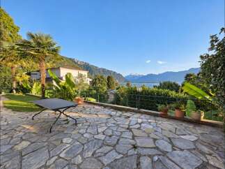 Experience breathtaking lake and mountain views from this stunning property's expansive stone patio.