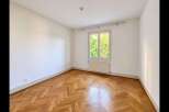 This unfurnished room features a beautiful herringbone hardwood floor that adds warmth and character.