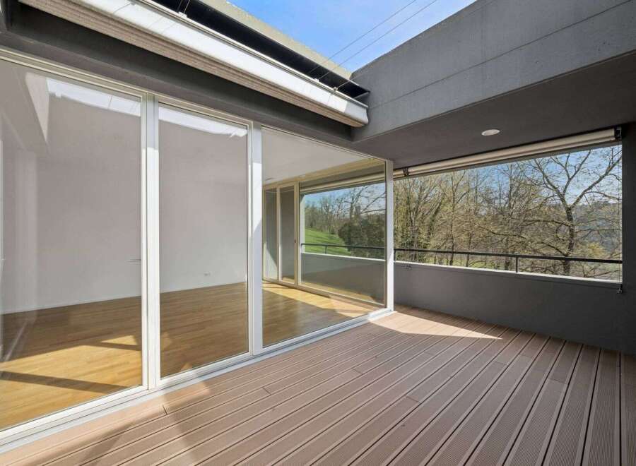 Experience luxury living with this stunning property featuring expansive glass doors that seamlessly connect the interior to a private balcony.