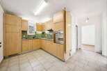 This stunning kitchen boasts modern cabinetry and a sleek design, perfect for culinary enthusiasts.