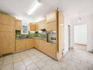 This stunning kitchen boasts modern cabinetry and a sleek design, perfect for culinary enthusiasts.