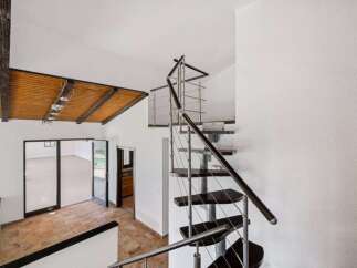 Experience modern living with this stunning spiral staircase, a true architectural statement.